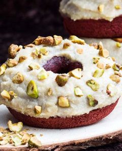 Closeup of Red Velvet Doughnuts with chopped pistachios on top