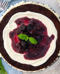 Gluten Free Cherry Filled Chocolate Cake on a serving platter topped with cherries