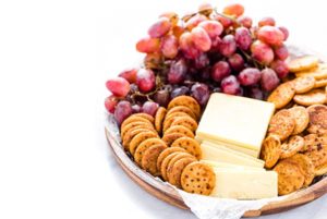 Gluten Free Seasoned Crackers on a platter with cheese and grapes