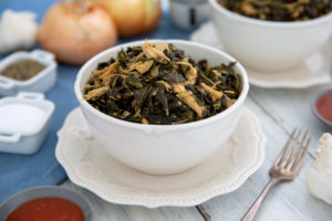 Healthy Southern Collard Greens in a white bowl on an elegant white plate