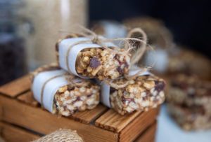 Chocolate Cherry Crispy Rice Treats wrapped in parchment paper on a wooden block