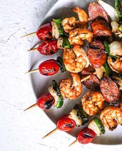 Shrimp and Andouille Sausage Skewers on a white plate