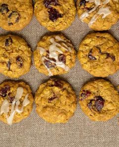 Pumpkin Cookies with cranberries lined up on a burlap background