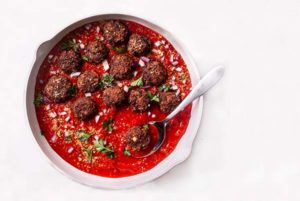 Vegetarian Italian Meatballs in red sauce in a white bowl on a white background