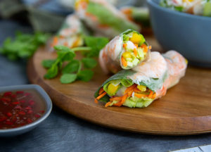 Closeup of Fresh Spring Rolls on a wooden serving tray