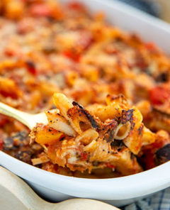 Closeup of Gluten-Free Baked Penne with Roasted Vegetables in a white serving dish