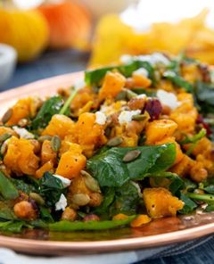 Closeup of a Butternut Squash and Kale Fall Salad on a bronze oval serving platter